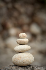 Fototapeta na wymiar stack of balanced rocks against rocky background