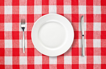 orange plate on red checked tablecloth