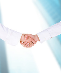 Two woman shaking hands