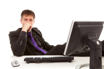Businessman sitting behind desk over white background