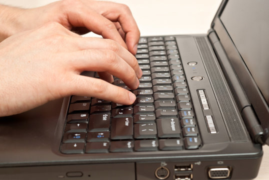 Hands on laptop keyboard