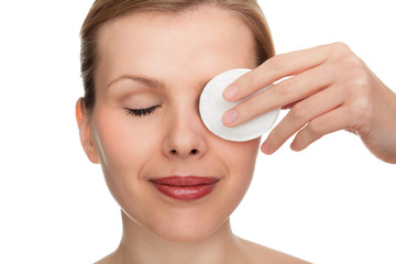 woman using a makeup remover pad