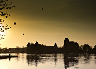 Hot air ballon over the lake in night.