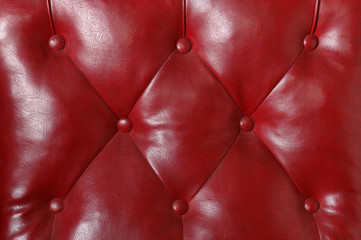 Padded red leather on a furniture, horizontal background