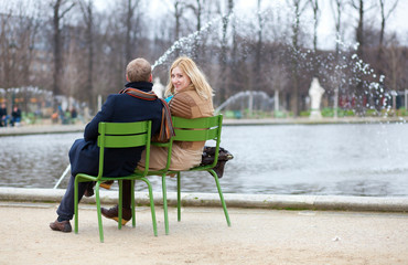 Couple in Paris, sitting in the Tuilleries park