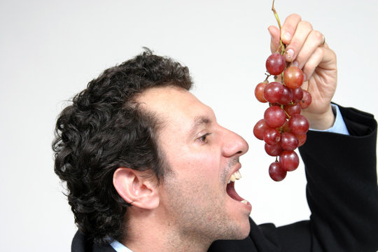 Healthy Man Eating Black Grapes, Healthy Food Photo