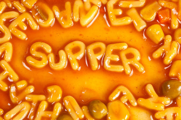 Pasta forming the word SUPPER in tomato sauce