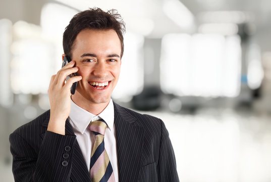Young businessman talking at phone