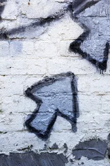 Poster Graffiti Blue graffiti arrows on a whitewashed brick wall