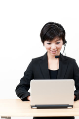 asian business operator using laptop computer