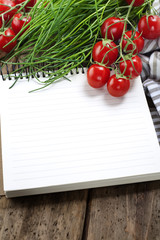 Open notebook and fresh vegetables