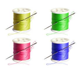 Spool of thread with a needle on a white background