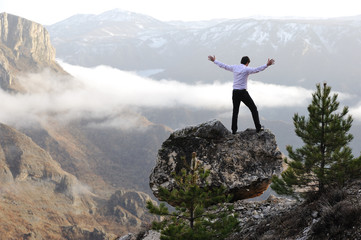 Man on top of mountain with open arms. Conceptual design