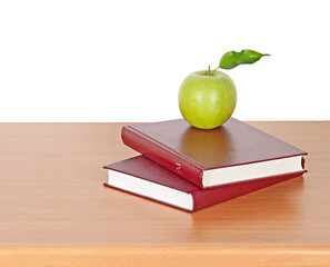 apple and books on desk