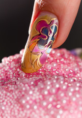 Long acrylic fingernail with beautiful multilayer manicure