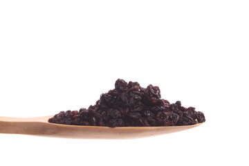 Currants on a wooden spoon