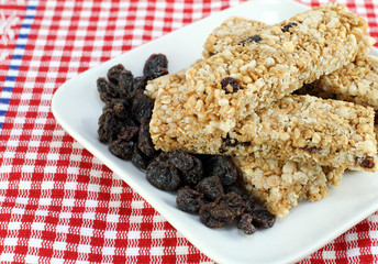 Healthy stack of raisin, nut granola bars.