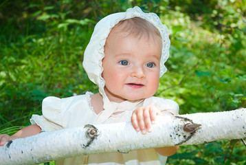 infant girl enjoying sunny day in forest