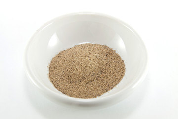 Pile of dried pepper leaves on a white background