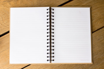Open blank note book on  wood