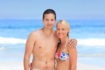 Fototapeta premium Woman huging her husband on the beach