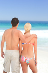 Fototapeta premium Woman huging her husband on the beach