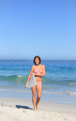 Lovely woman with her surfboard