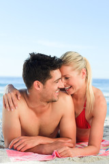 Fototapeta premium Lovers lying down on the beach
