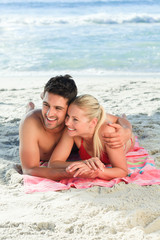 Fototapeta premium Lovers lying down on the beach