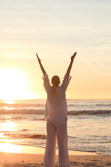 Woman practicing yoga during the sunset