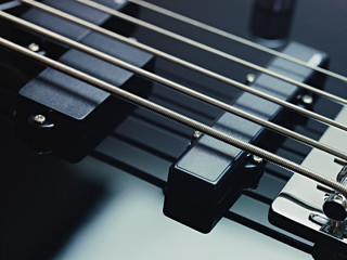 detail of electric bass, pickups and cords