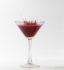 red martini cocktail splashing