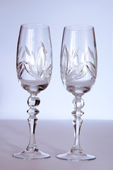 two crystal wedding glasses on a gray background