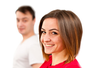 Cute smiling girl face with guy in background. Isolated on white