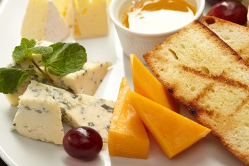 Cheese plate with grapes and honey