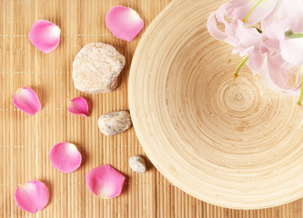 A spa composition of flowers, stones, petals and bamboo