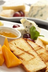 Cheese plate with grapes and honey