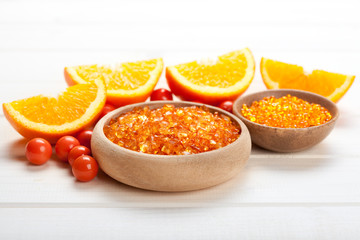 Fototapeta na wymiar Orange bath salt and ripe fruits