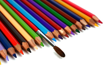 crayons coloured pencils and brush for paints