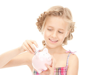 little girl with piggy bank and money