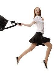 Fototapeta premium The red girl in a black skirt runs on a white background