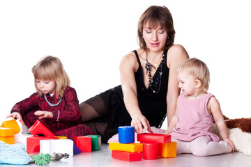 Obraz na płótnie Canvas Children with mother playing with blocks