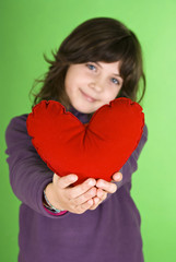 Happy little girl with red valentines heart