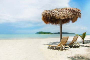 chairs and umbrella on sand beach
