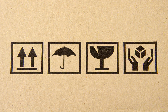 Image close-up of grunge black fragile symbol on cardboard