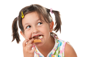 Little girl biting a snack