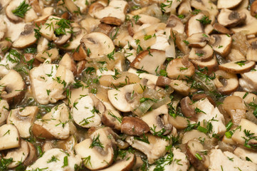 Closeup of mushrooms frying in a pan