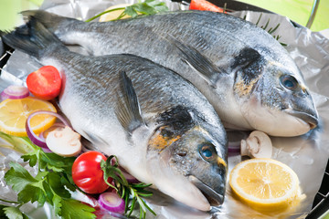 gilt-head with the vegetables on a grill