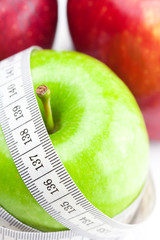 apple and measure tape isolated on white