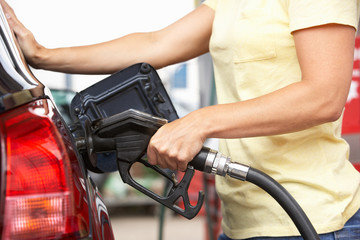 Detail Of Female Motorist Filling Car With Diesel At Petrol Stat